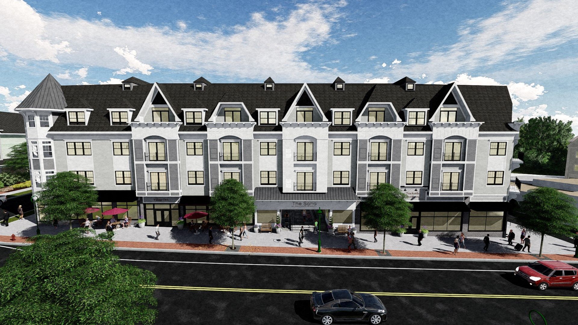 Multi-story building with retail on the ground floor. Gray facade, black roof, and blue sky.