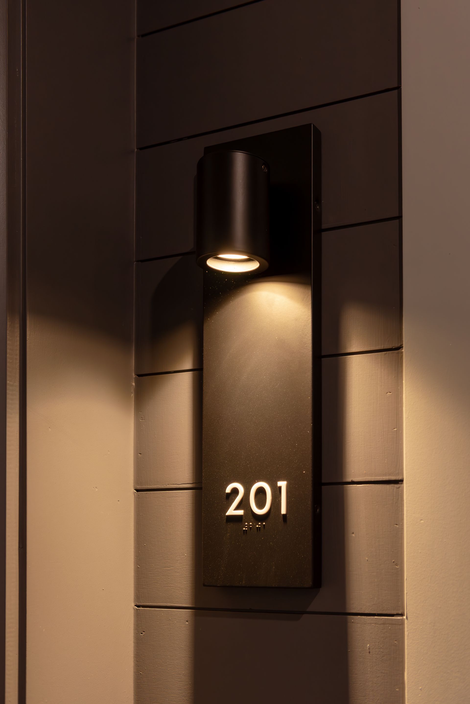 Black illuminated address sign with 