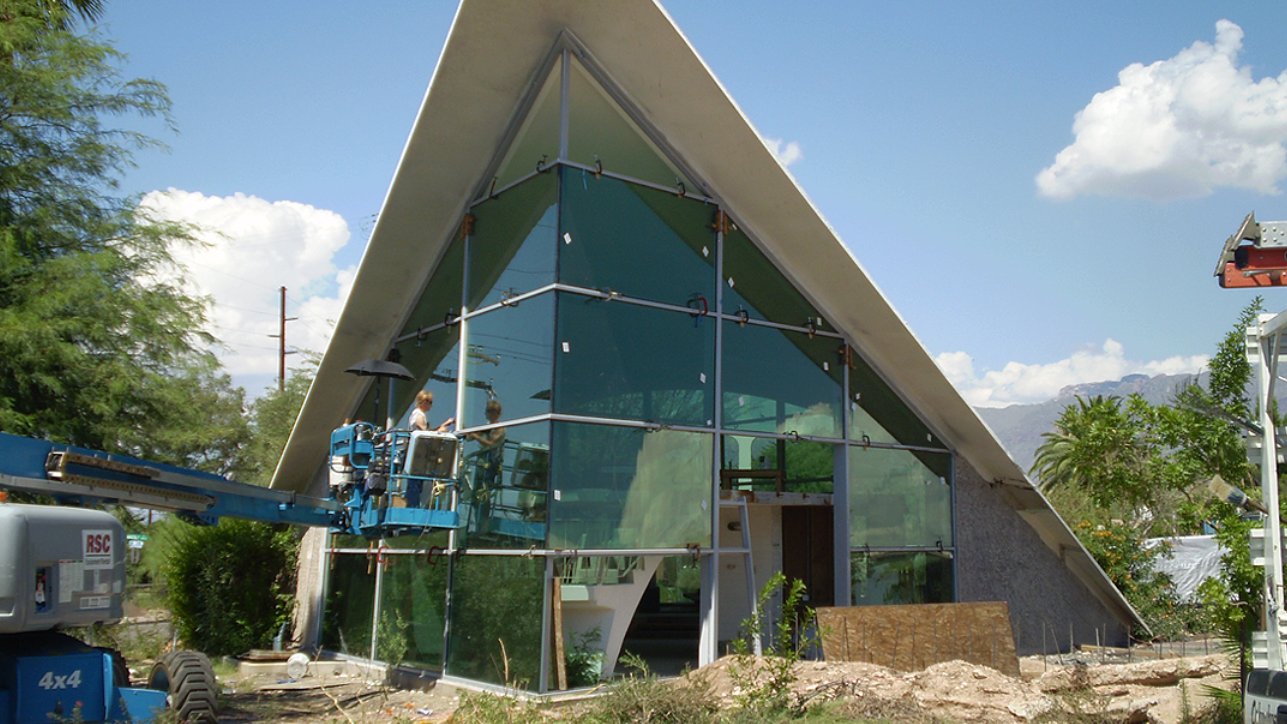 Black car engine bay with various components, including coolant reservoirs and air intake.