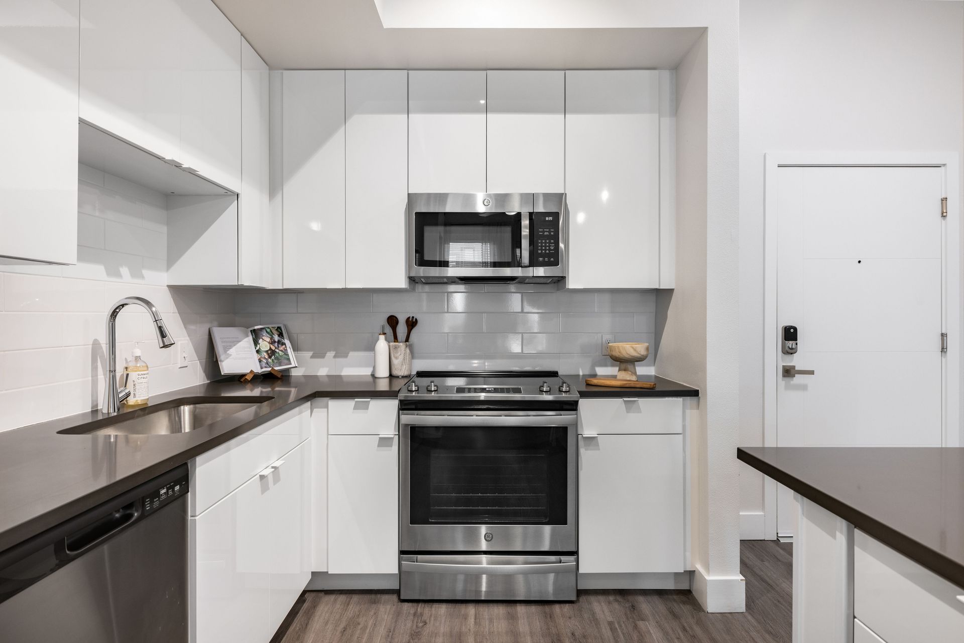 A kitchen with white cabinets and stainless steel appliances.
