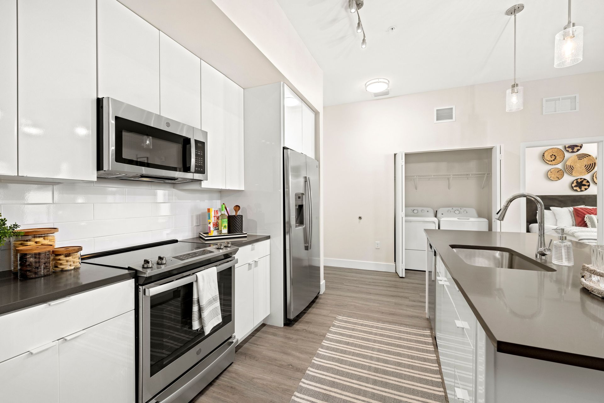 A kitchen with white cabinets and stainless steel appliances.