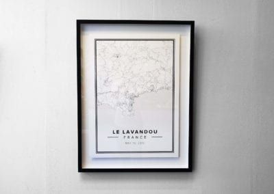 A framed map of france is hanging on a white wall. by Fulham Framing.