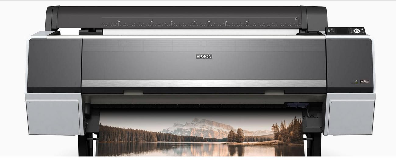 A large printer with a picture of a lake on it. Photo printing and framing.