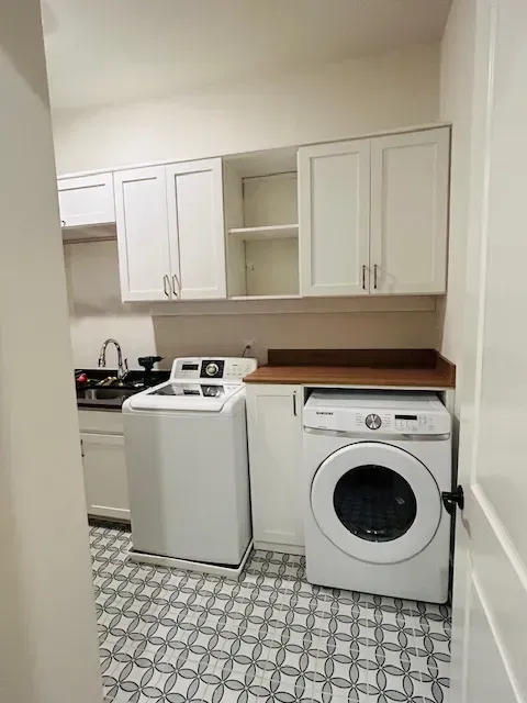 This laundry room combines storage with function, featuring a folding countertop over the dryer.