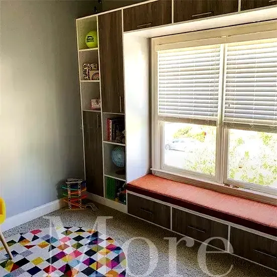 Closetopia integrates storage with seating, custom fitted around a bright window.