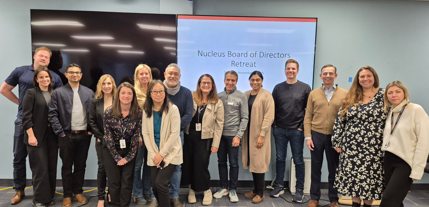 A group of people are posing for a picture in front of a building.