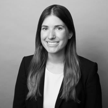 A man in a suit and tie is smiling for the camera.