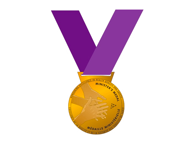 A gold medal with a purple ribbon and the letter v on it