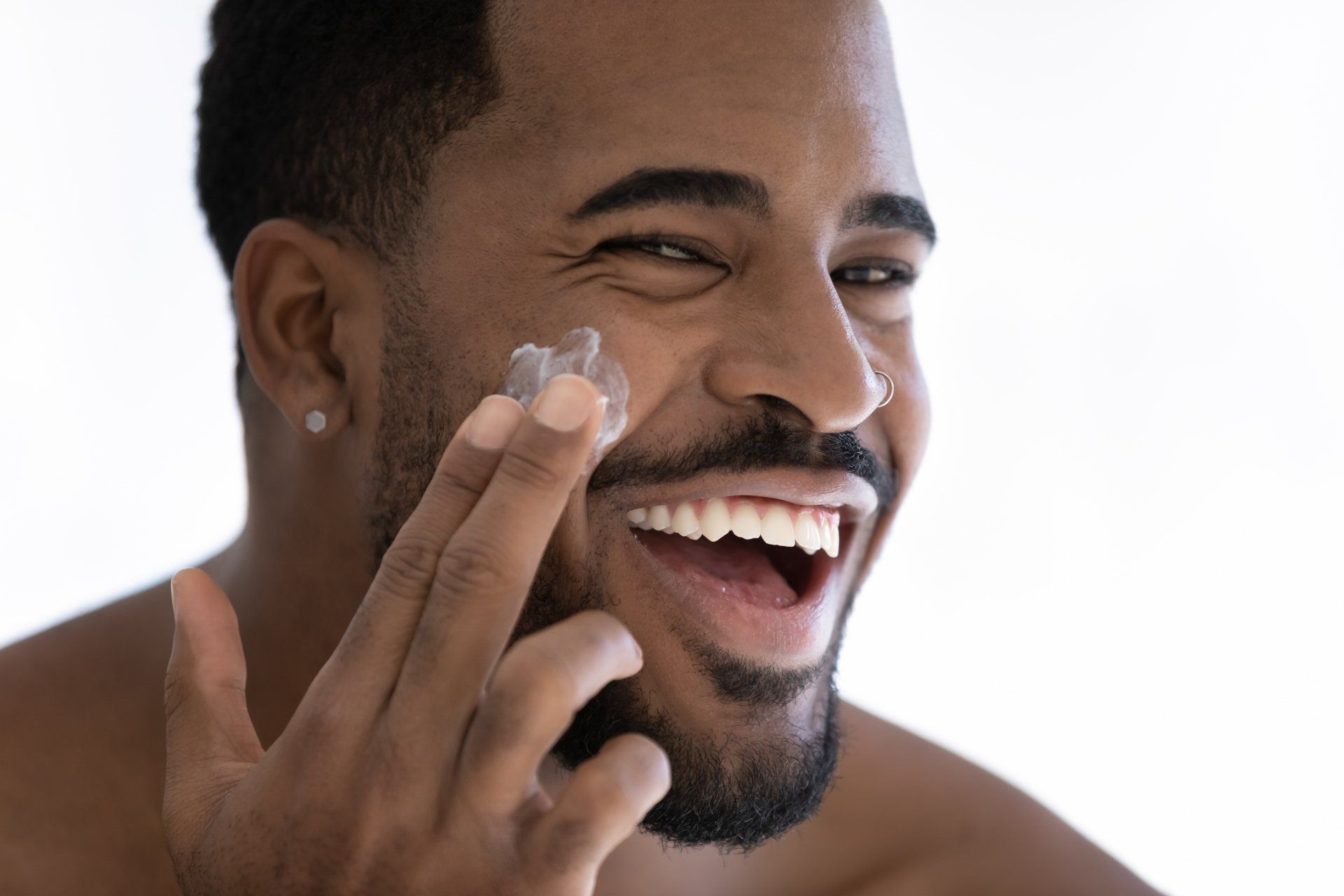 African American Male Applying Acne Topical Cream. Dermatologist Treats Acne for Skin of Color.