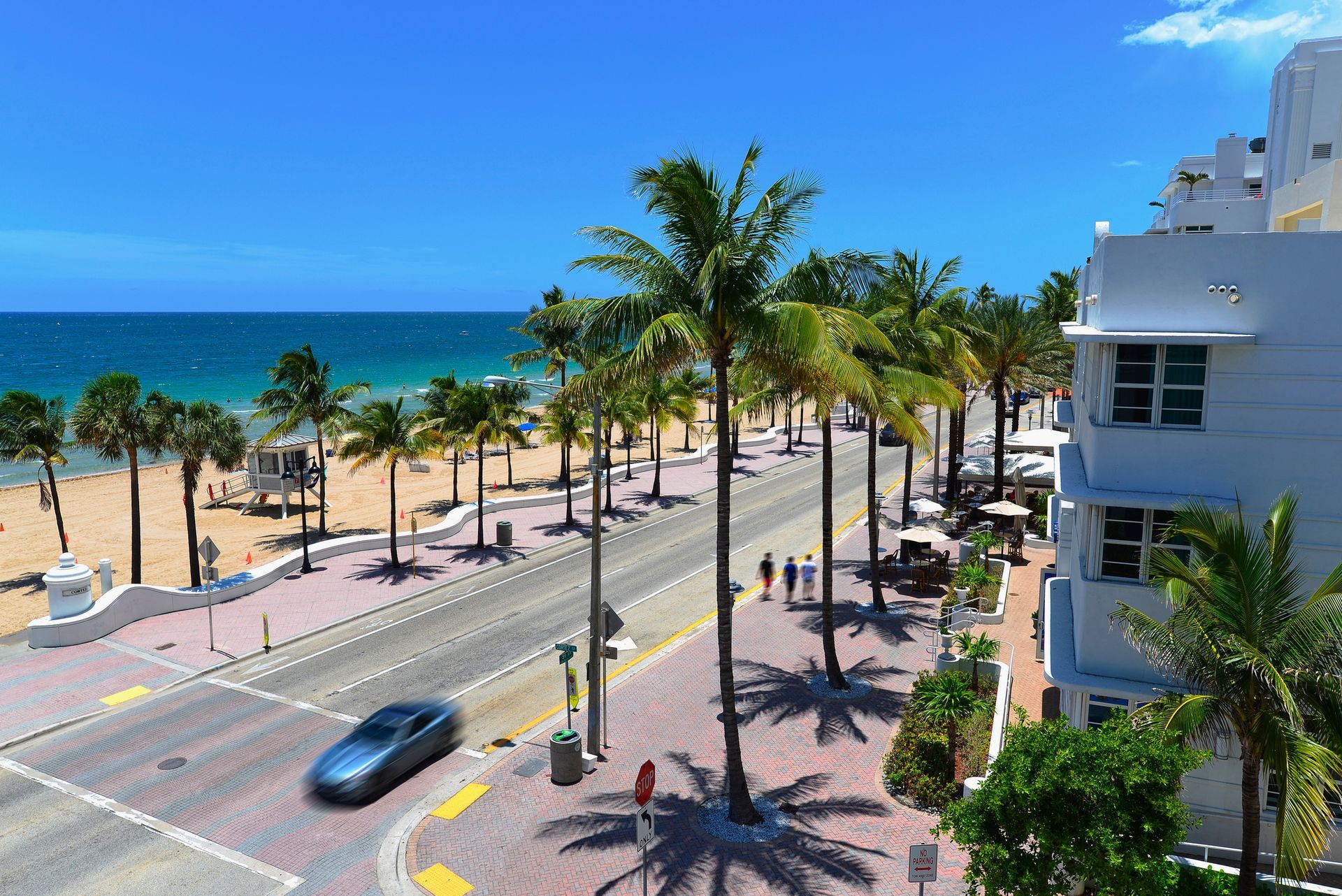 A man and woman are standing in front of a white house.