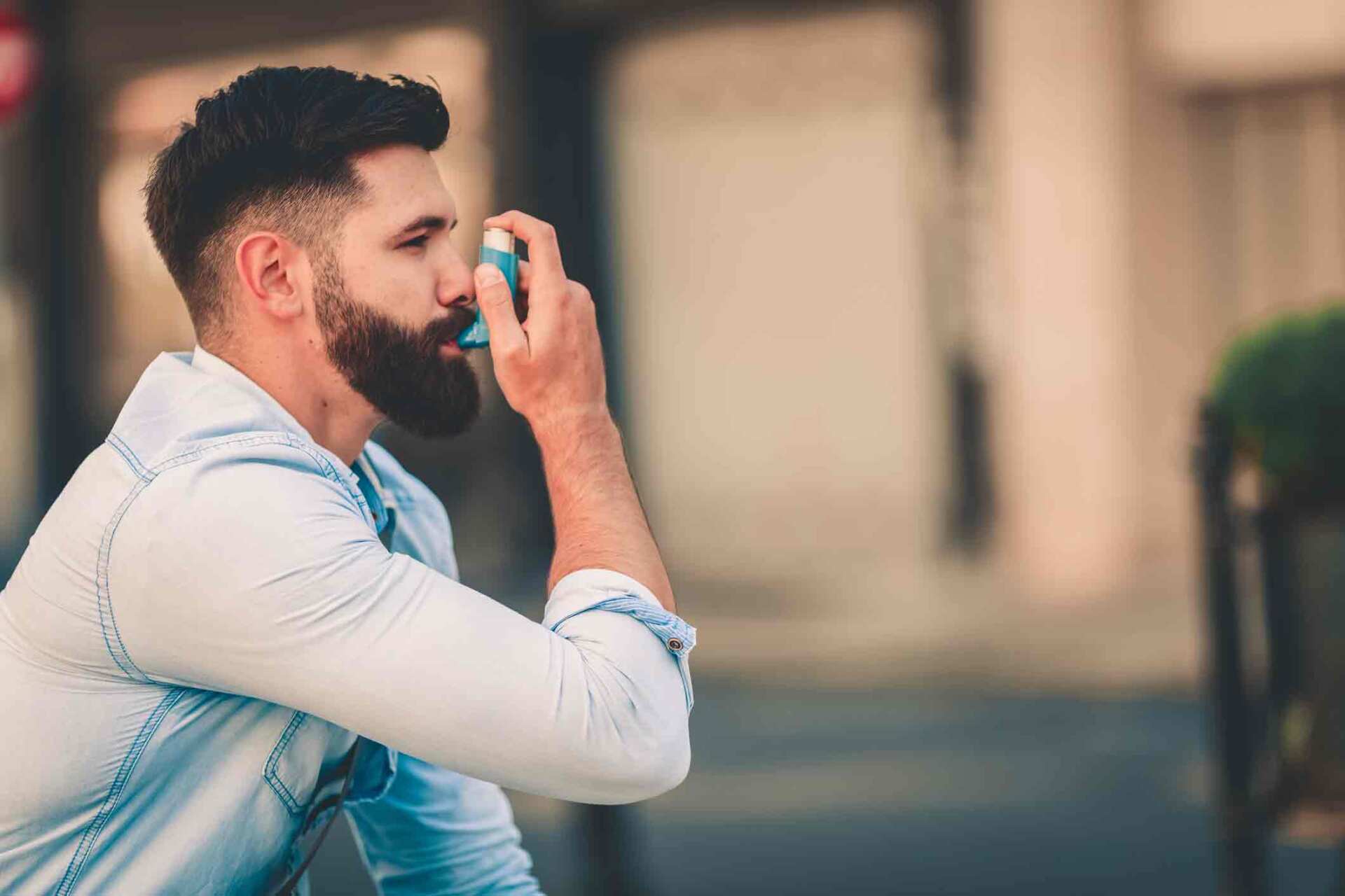 Man Using Inhaler — Lexington, KY — Allergy Asthma & Immunology: Dr. Iraklis Livas