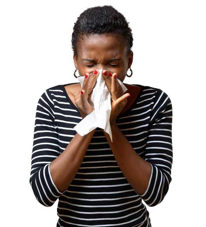 African Woman Sneezing — Lexington, KY — Allergy Asthma & Immunology: Dr. Iraklis Livas