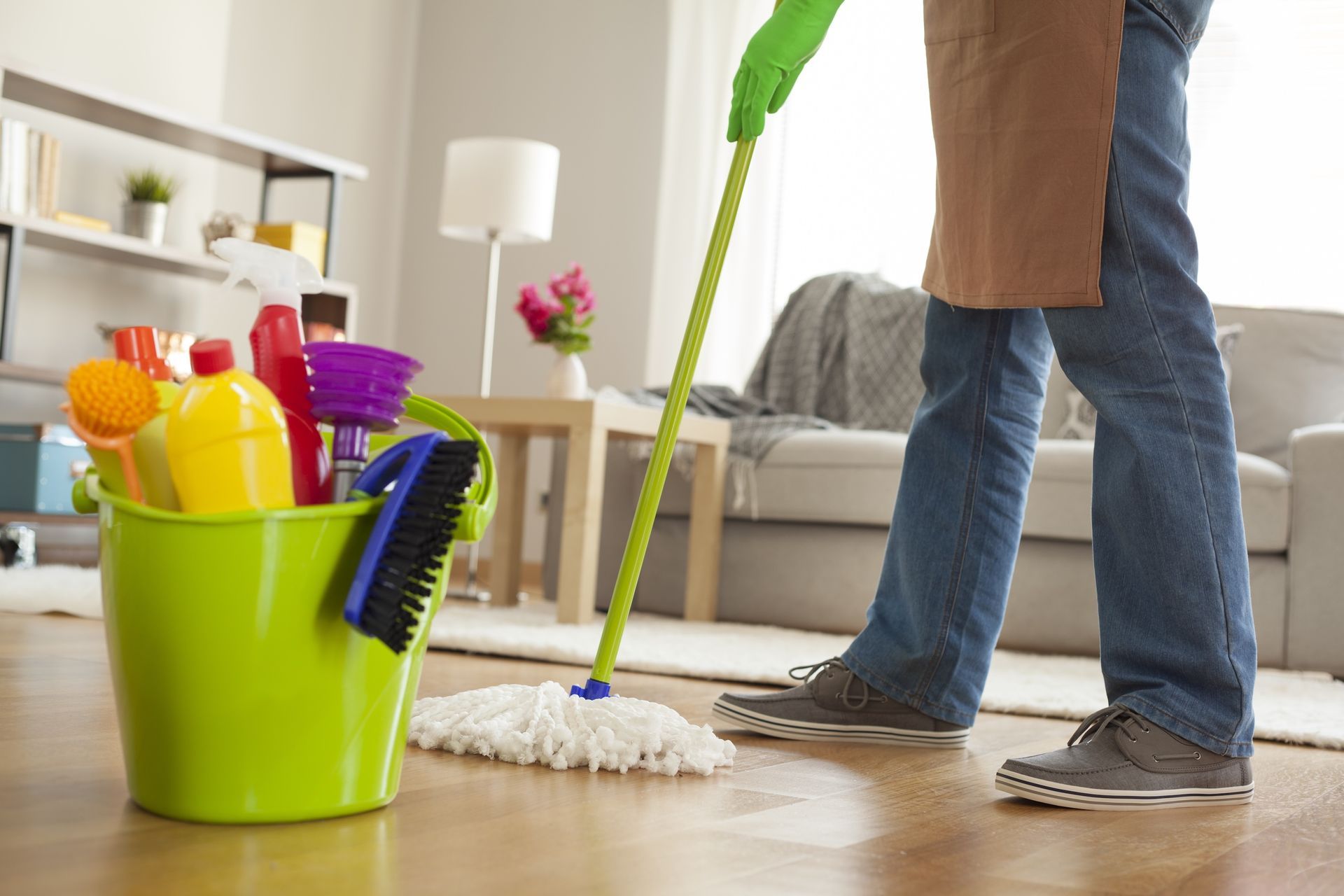 A Person Mops a Wooden Floor — Serena's Local Cleaning Company In Toowoomba, QLD