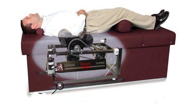 A man is laying on a table with a machine on it