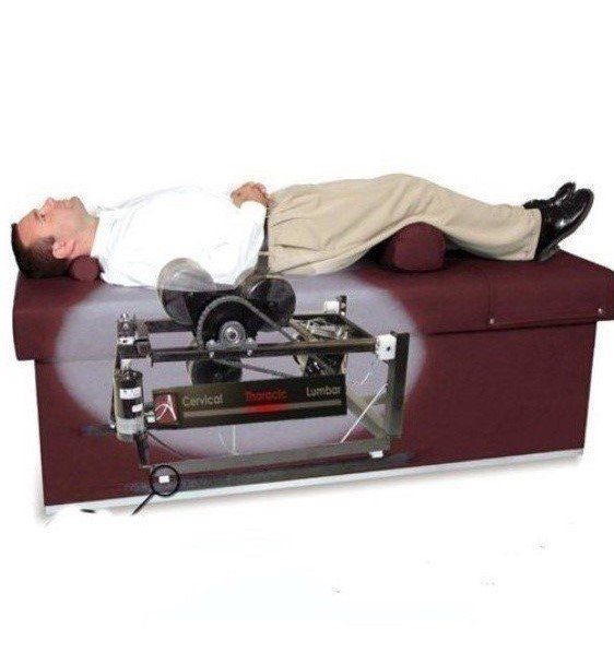 A man is laying on a table with a machine on it