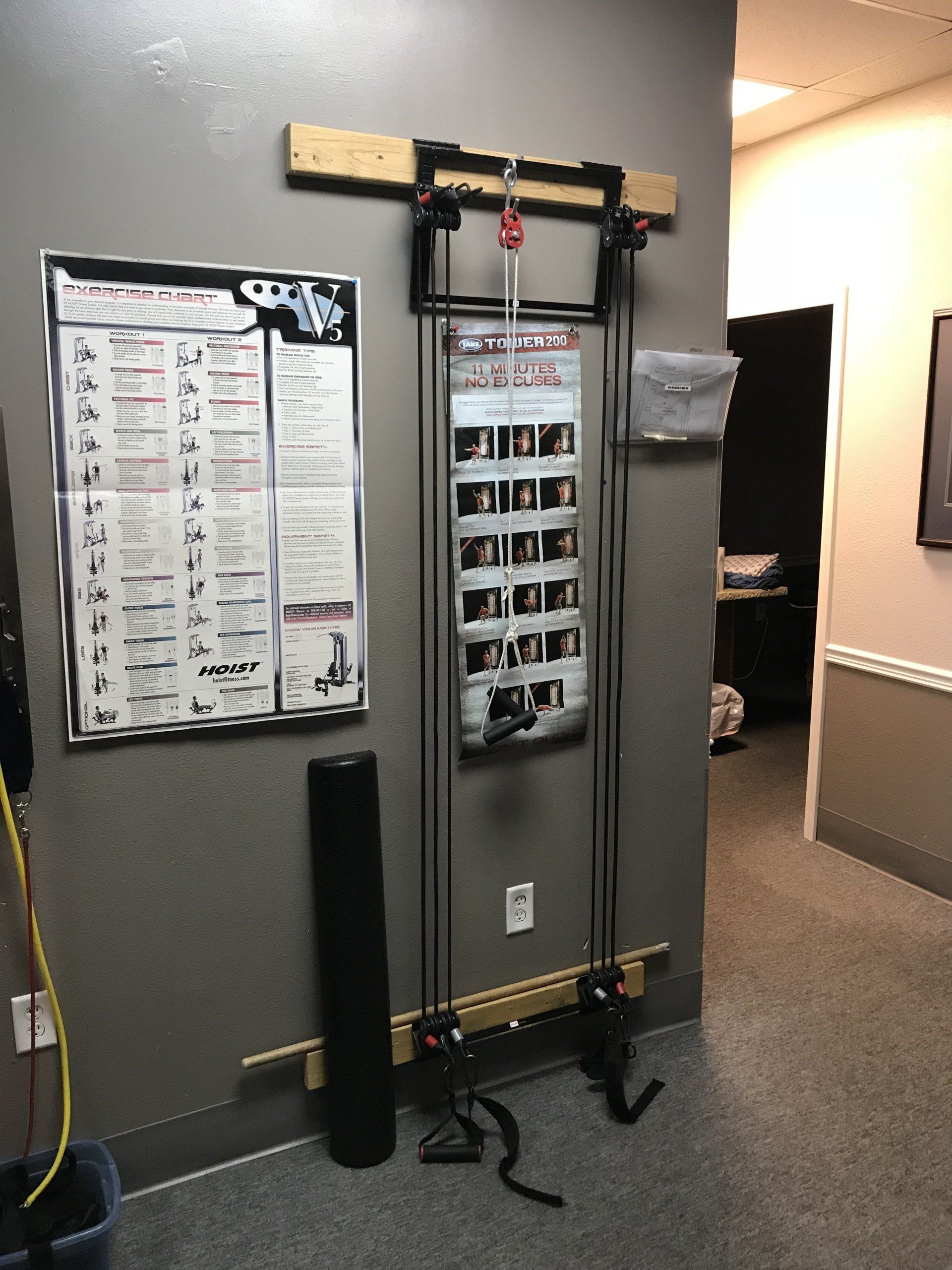 A wall mounted exercise machine with a poster on it