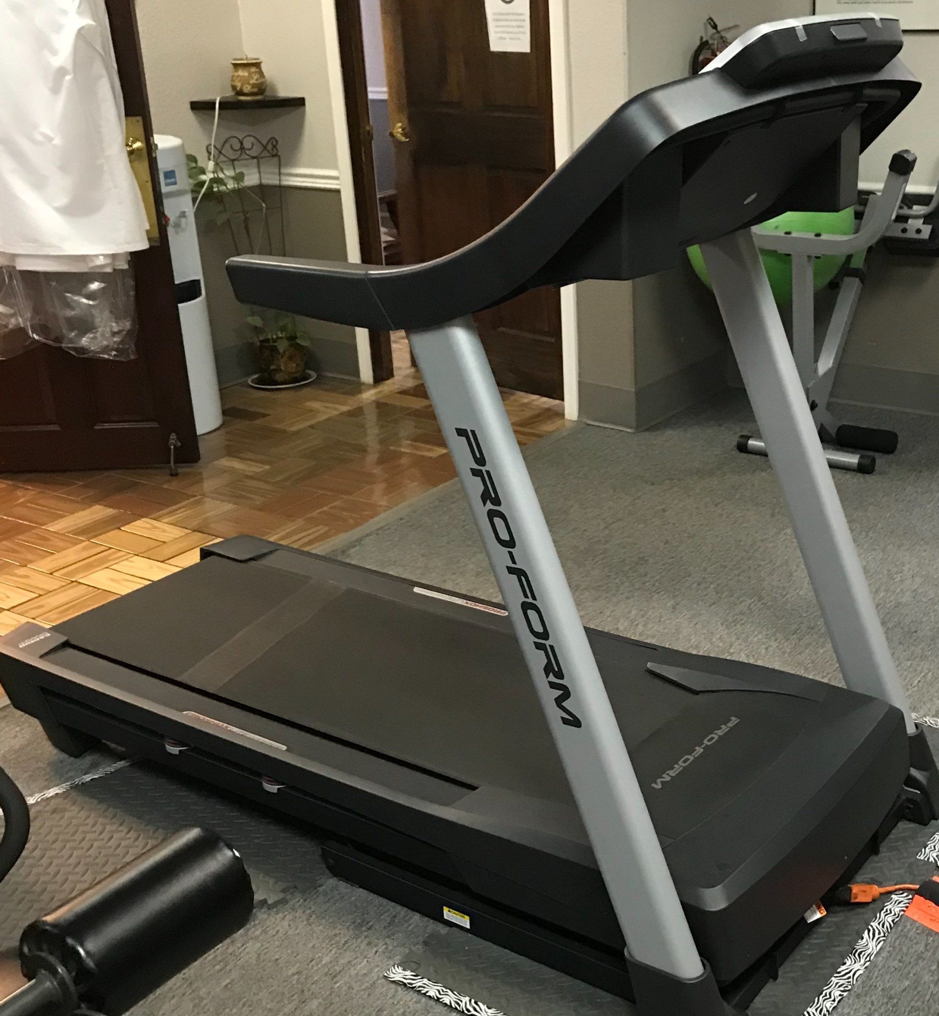 A treadmill is sitting on the floor in a room.