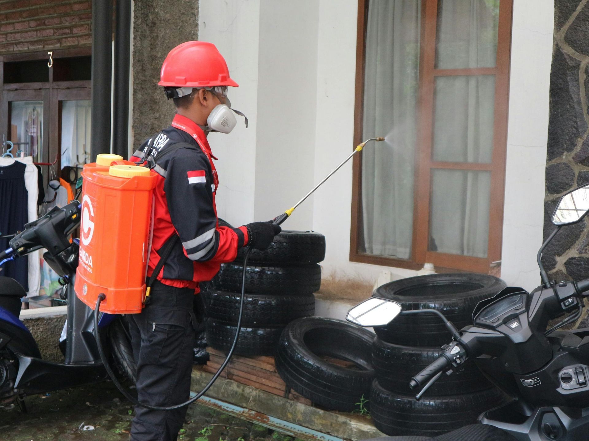 Professional pest control technician applying maintenance treatment with specialized equipment