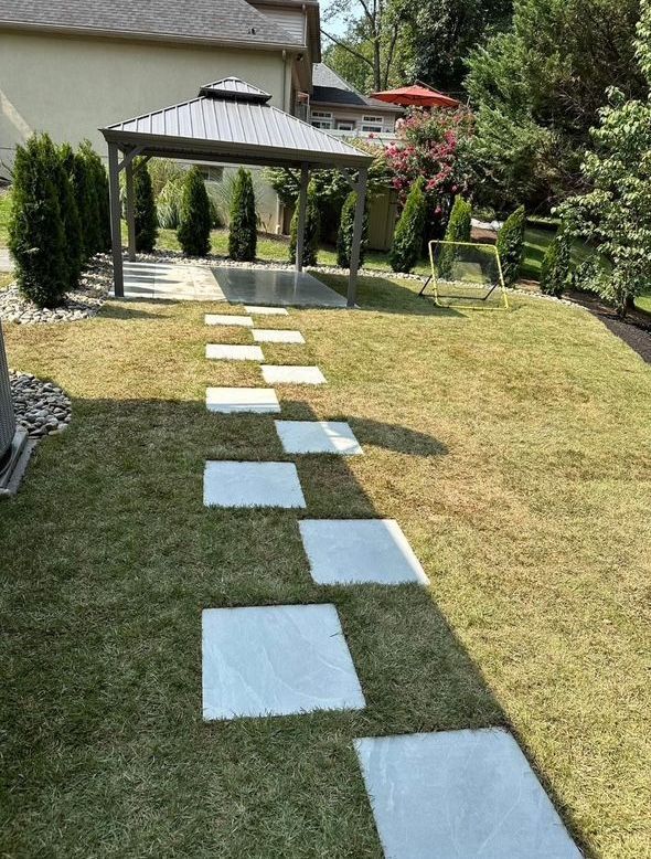 A lawn with a gazebo and stepping stones leading to it installed by complete property solutions of Lancaster PA