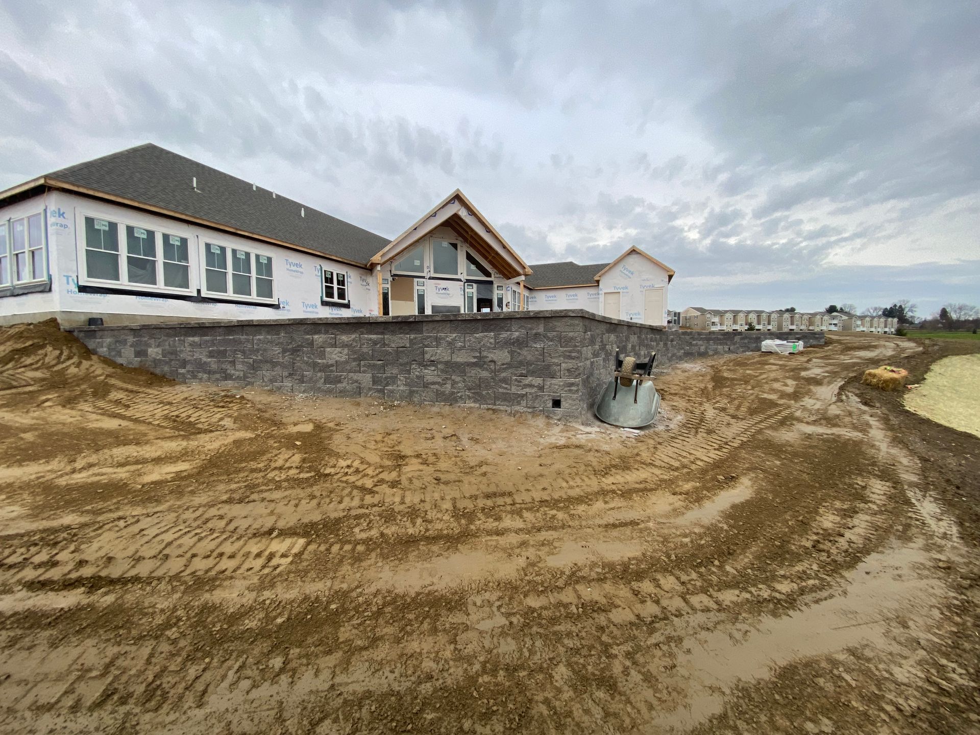 A large house is being built on top of a dirt hill with grading by complete property solutions of Lancaster PA