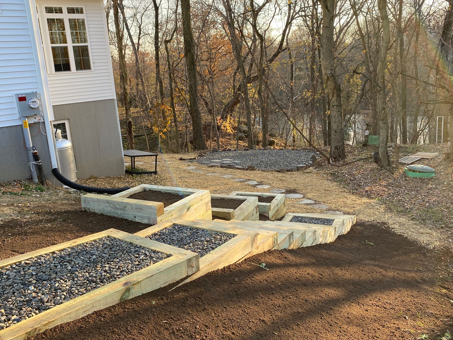 A house with a custom backyard walkway and stone stairs installed by complete property solutions of Lancaster PA