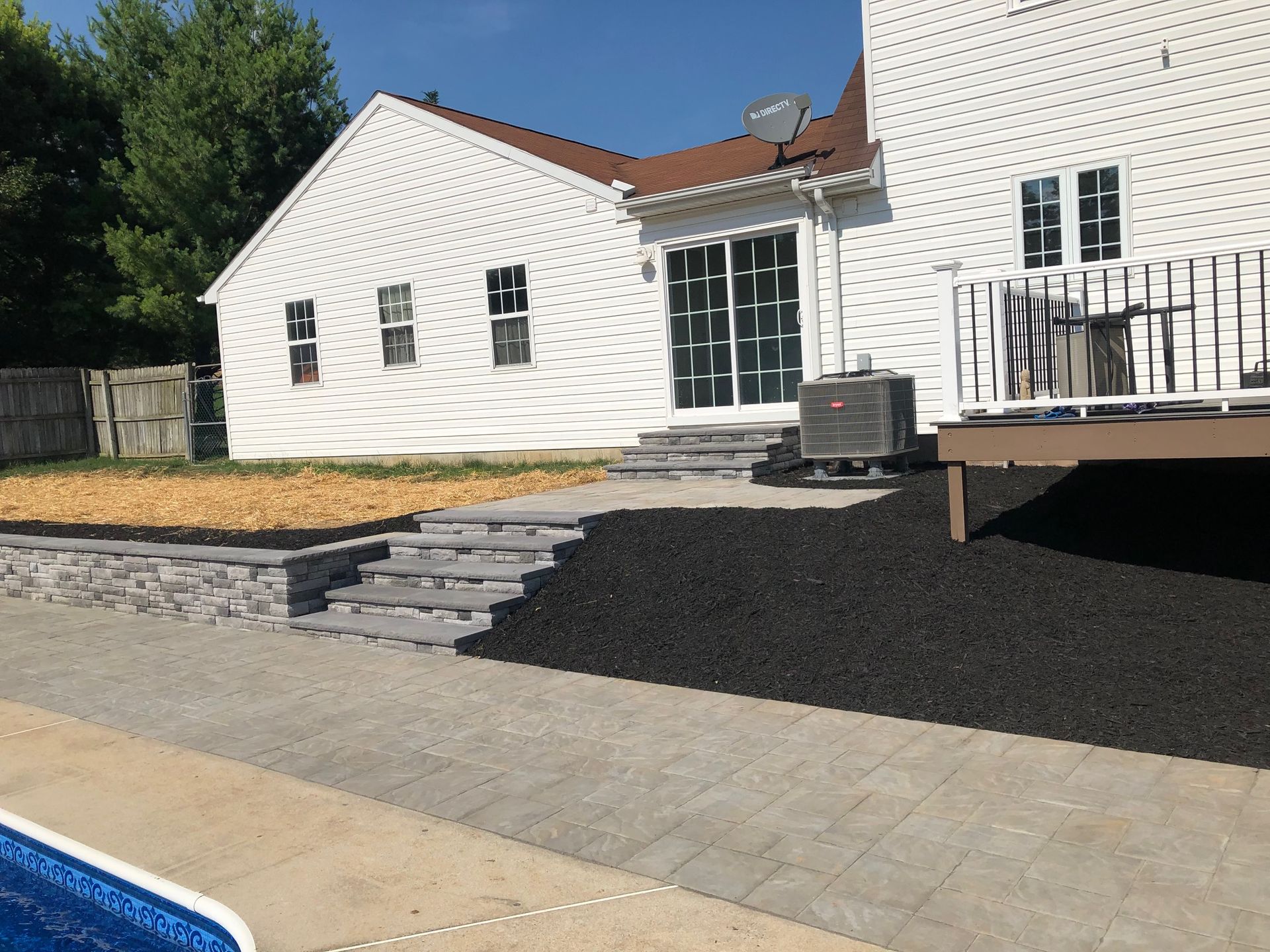 A white house with a swimming pool in front of it with landscaping by complete property solutions of Lancaster PA