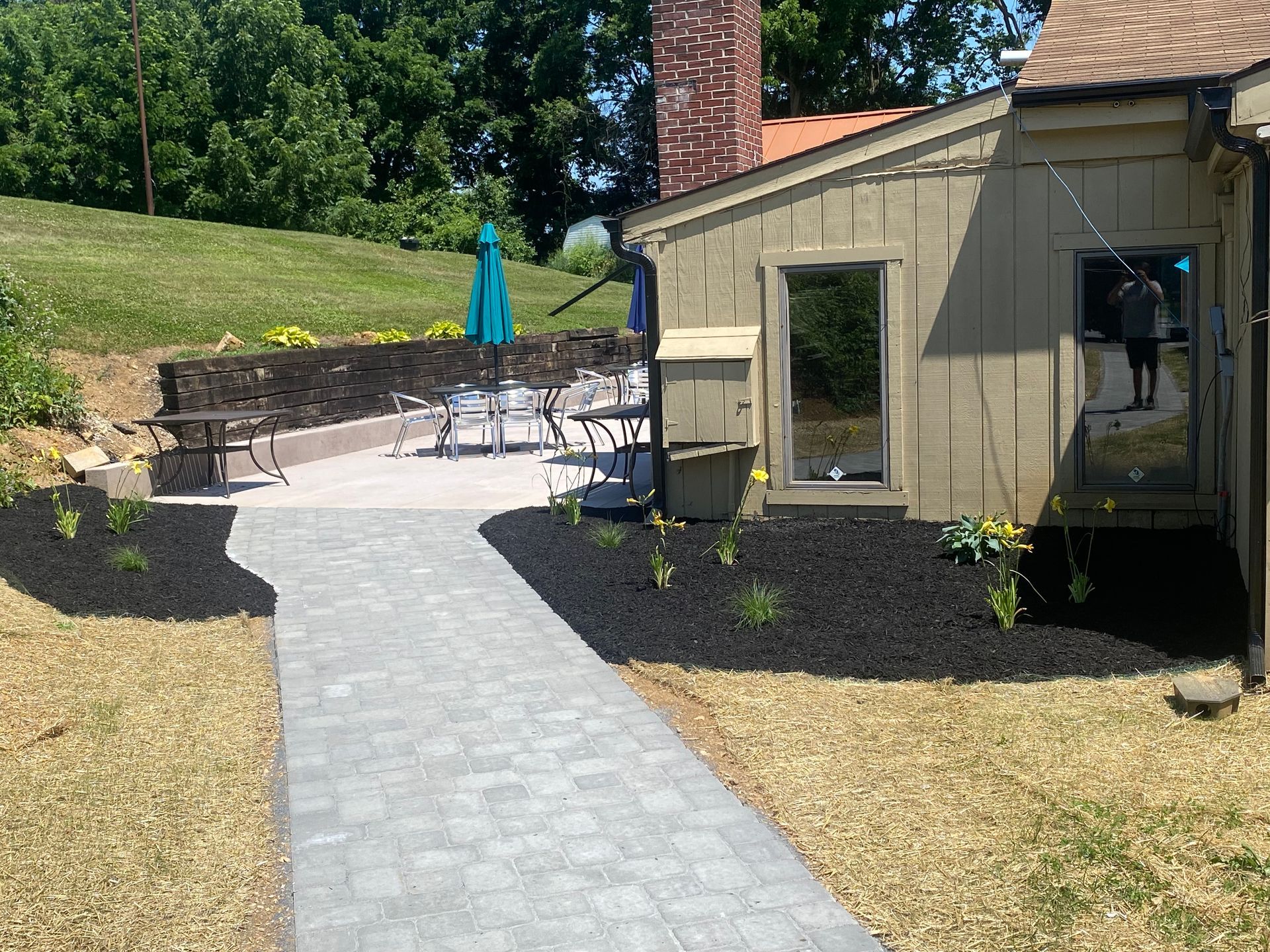 A house with a patio and a walkway leading to it installed by complete property solutions of Lancaster PA
