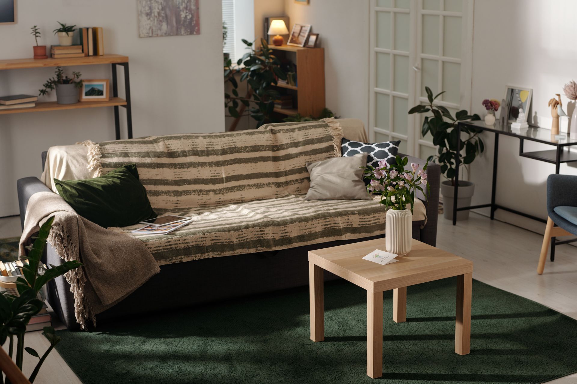 A living room with a couch , table , and rug.