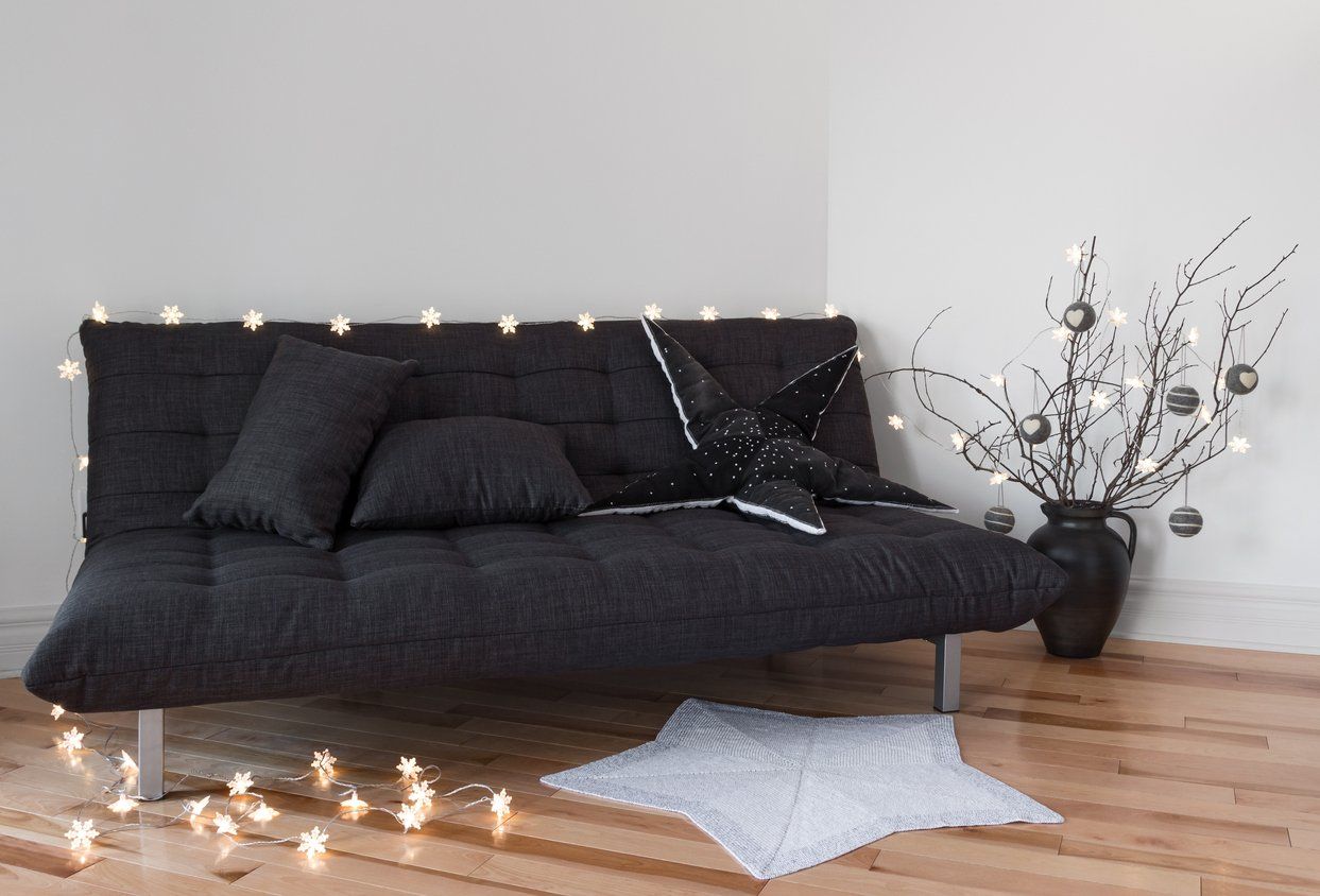 minimal and cozy futon with decor for guests during holidays