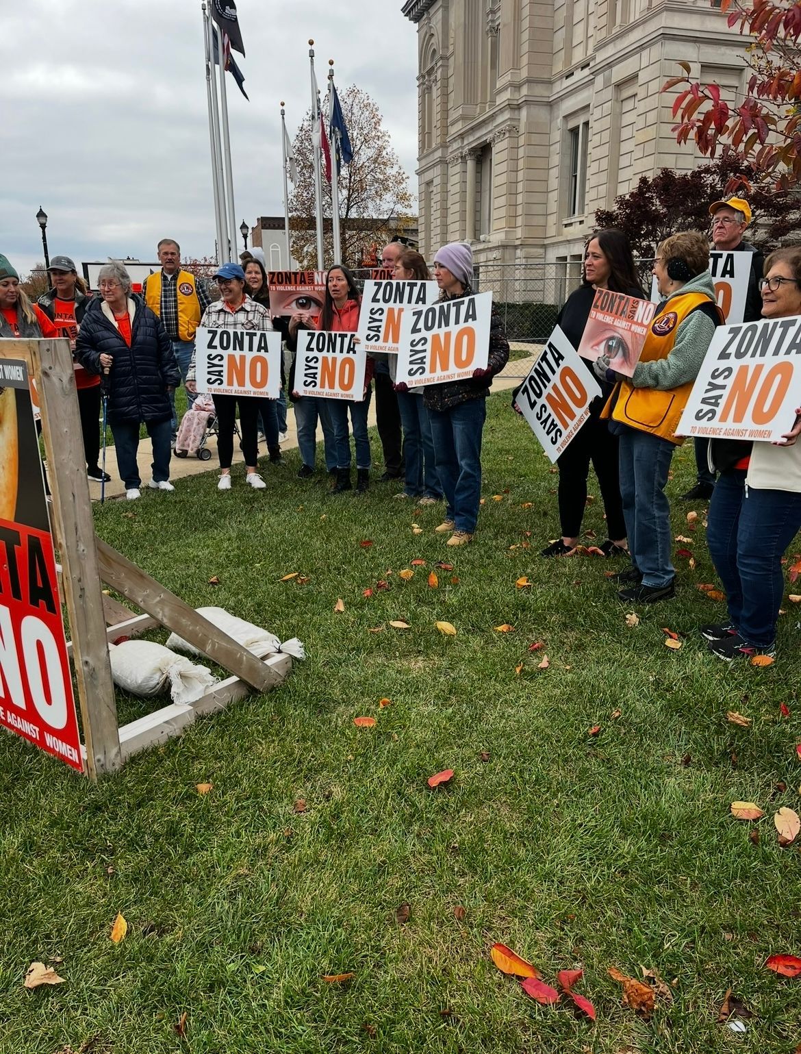 People protesting, holding signs that say