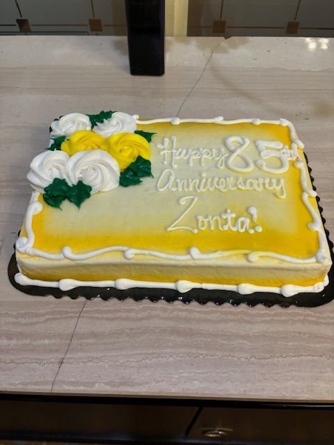 Cake decorated for 85th Anniversary of Zonta; yellow frosting, flowers.
