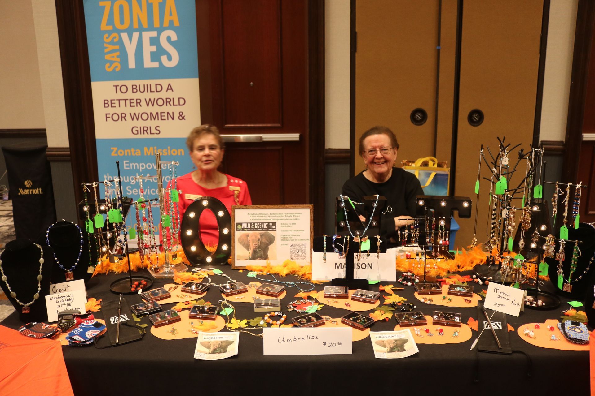 Two women at a Zonta booth, selling jewelry. Sign: 