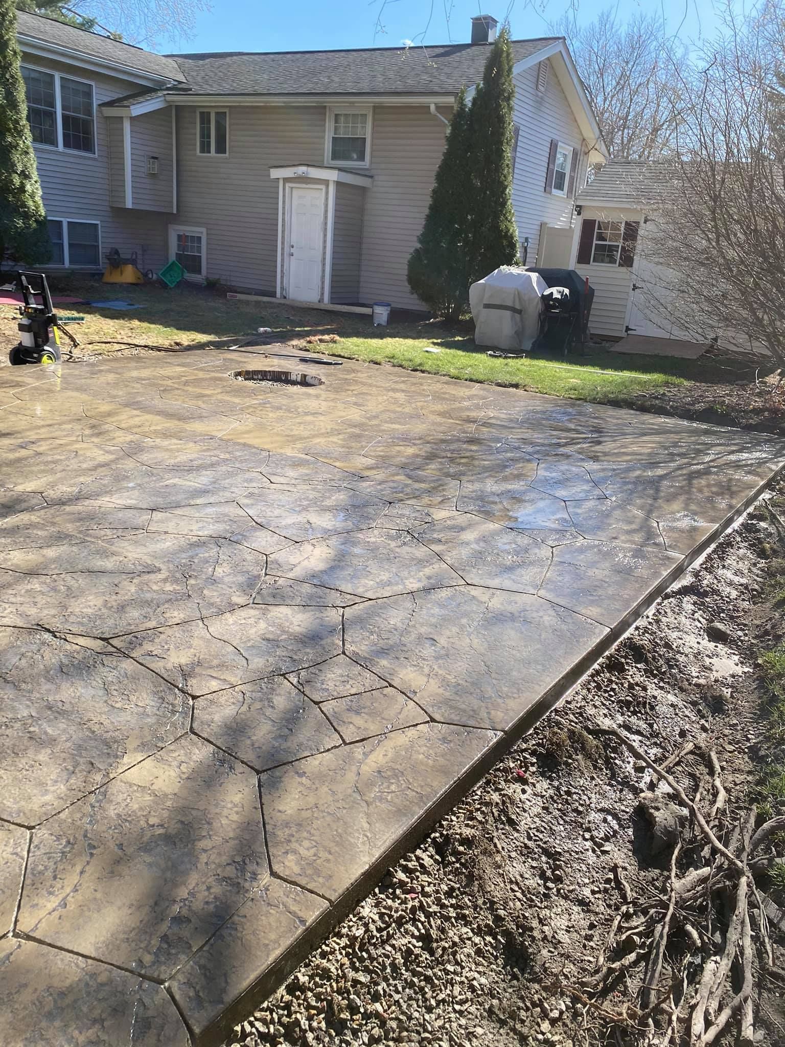 A house with a concrete driveway in front of it.
