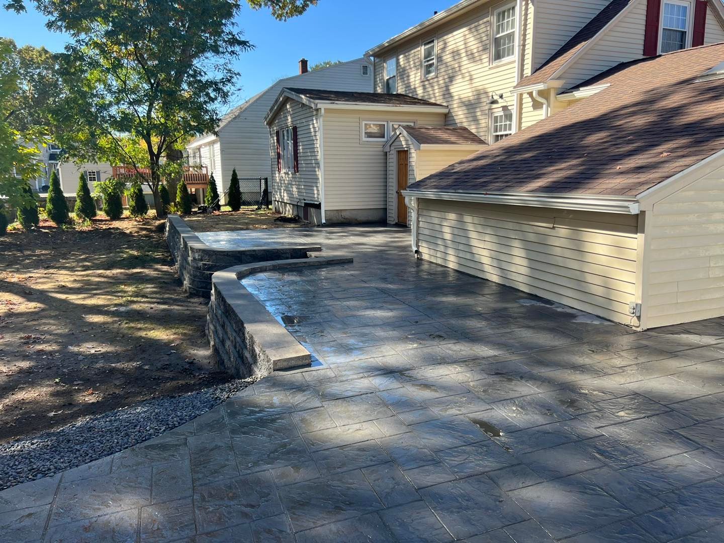 A house with a garage and a concrete driveway in front of it.