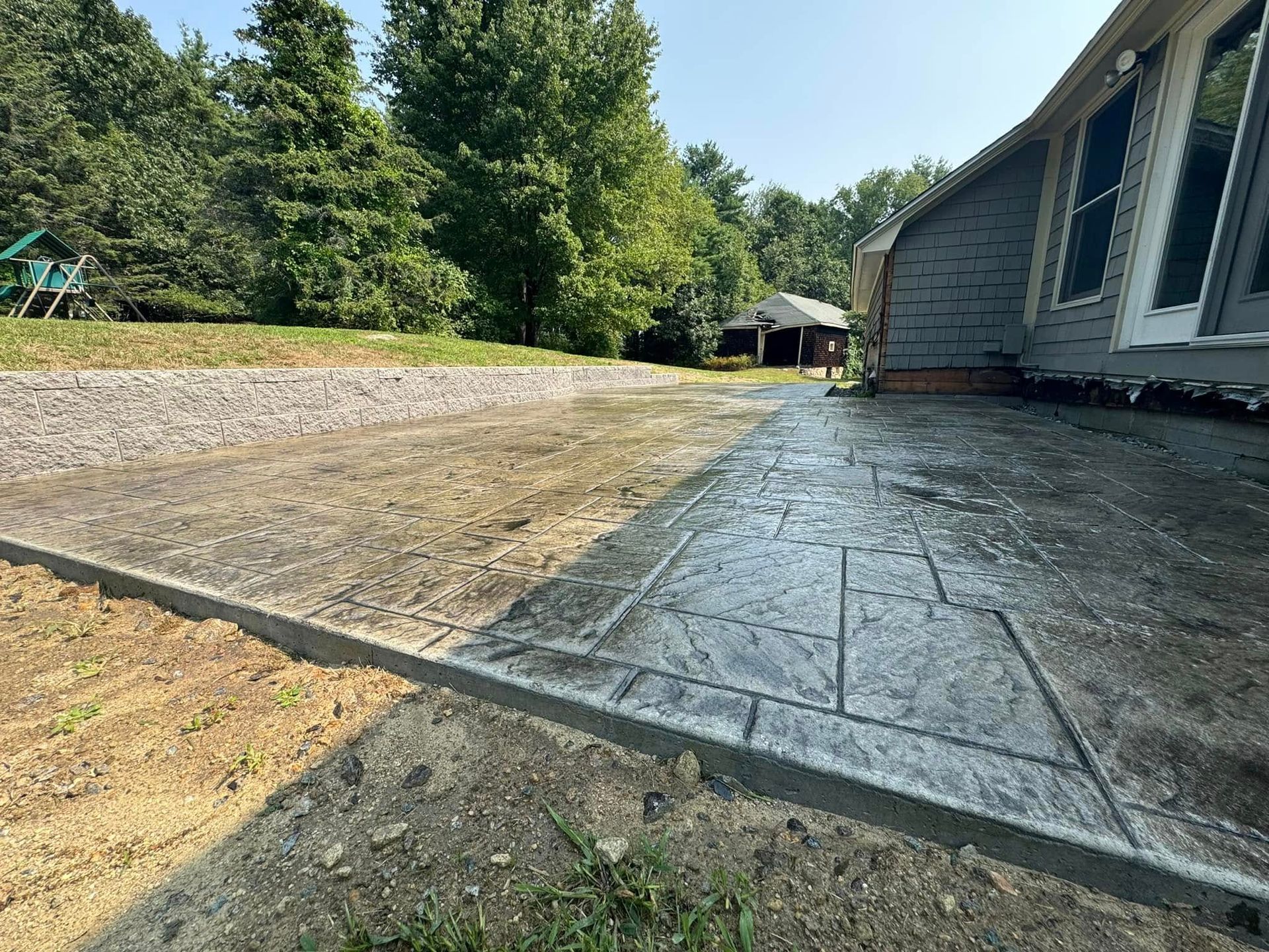 A concrete walkway is being built in front of a house.
