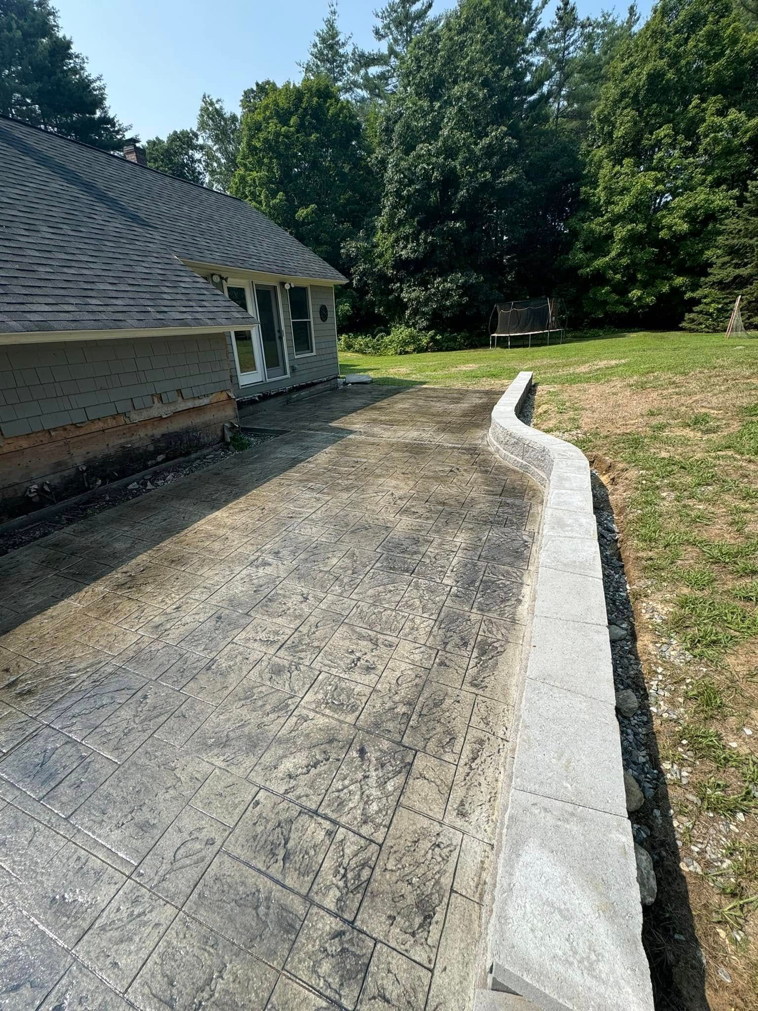 A concrete driveway is being built in front of a house.