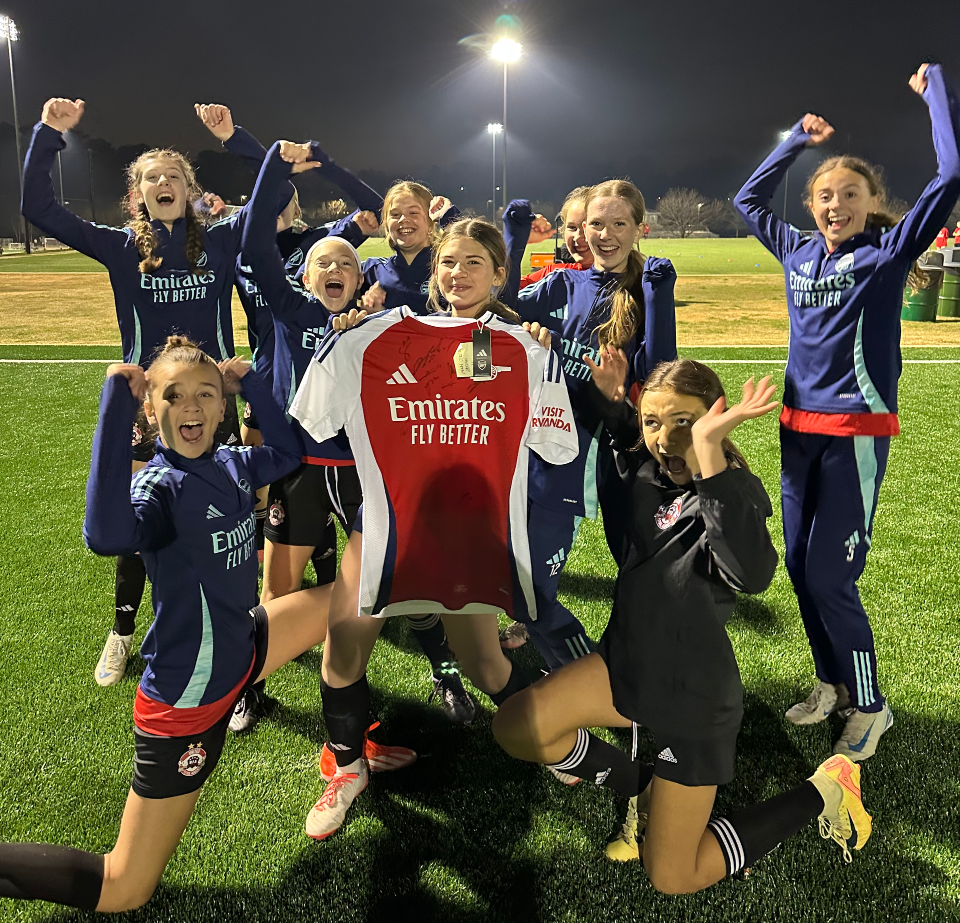United Futbol Academy players with an Arsenal jersey