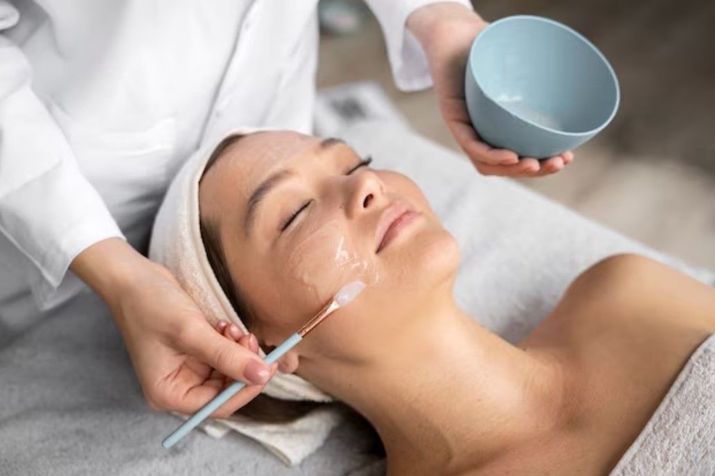 A woman is getting a facial treatment at a spa.