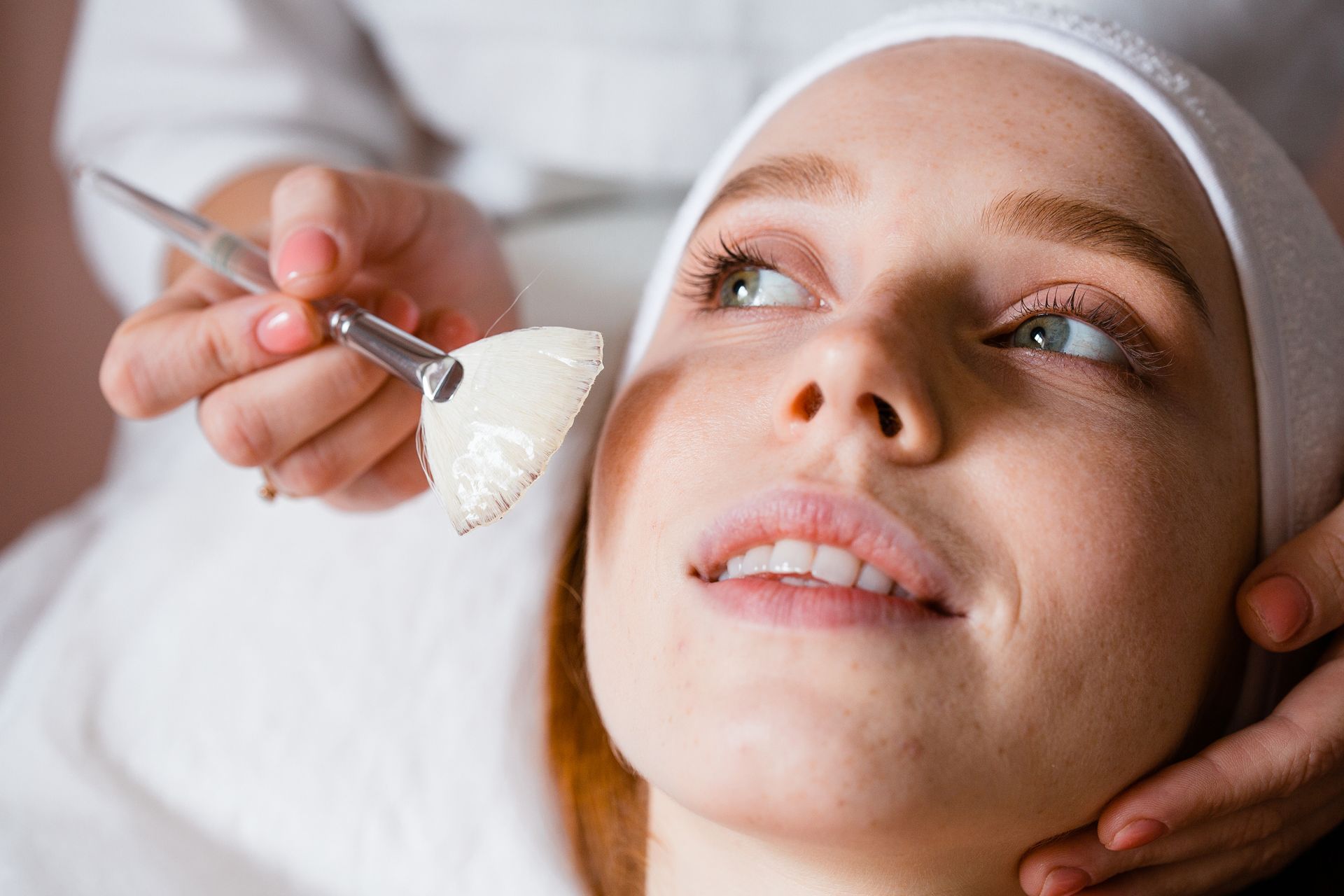 a woman is getting a facial treatment at a beauty salon .