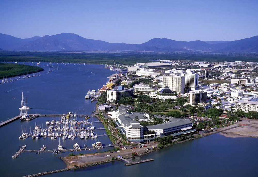An Aerial View Of A City Surrounded By Water And Mountains — Barron River Lawns In Cairns, QLD