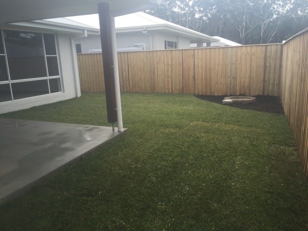 There is a Wooden Fence in the Backyard of a House — Boambee Turf In Bonville, NSW