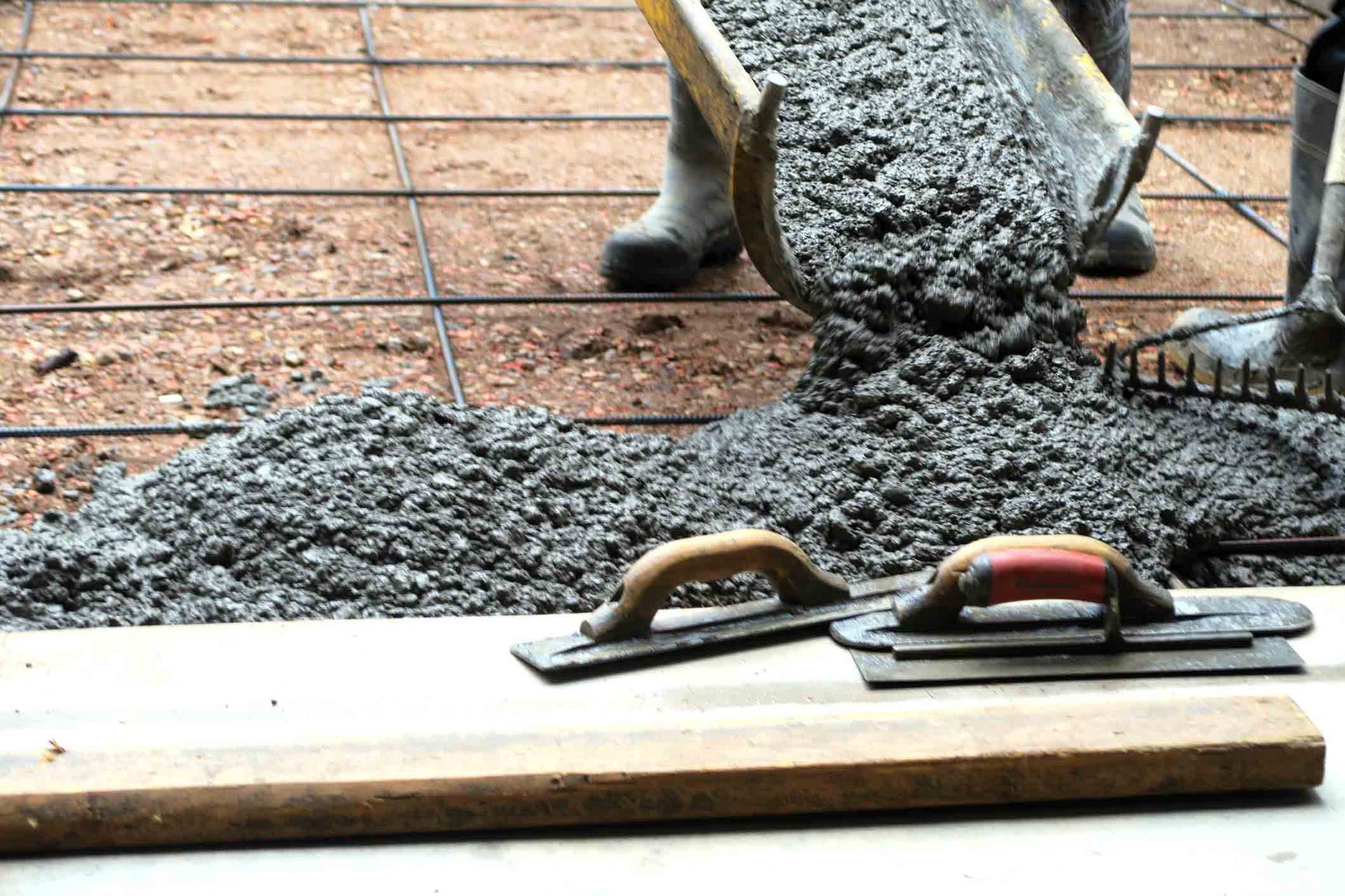 Make a concrete driveway- fresh cement from truck and trowels