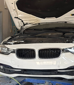 White BMW with Opened Hood is Ready for Repair in Houston, TX | Exclusive Collision And Customs