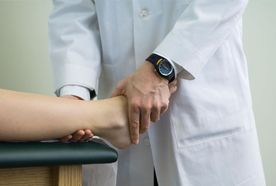 A therapist examining a patient's ankle