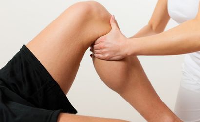 Therapist's hands on a patient's lower leg