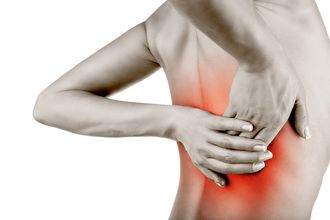 Hands on a back showing a red area where the pain is