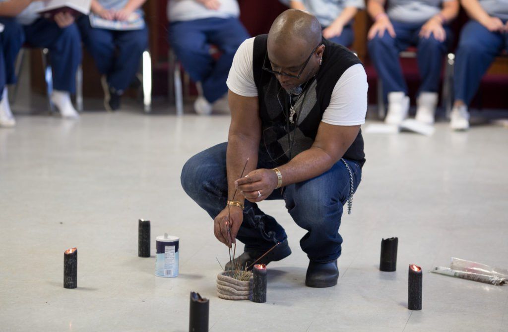 Wiccan clergy member offering spiritual guidance during a prison ministry visit.
