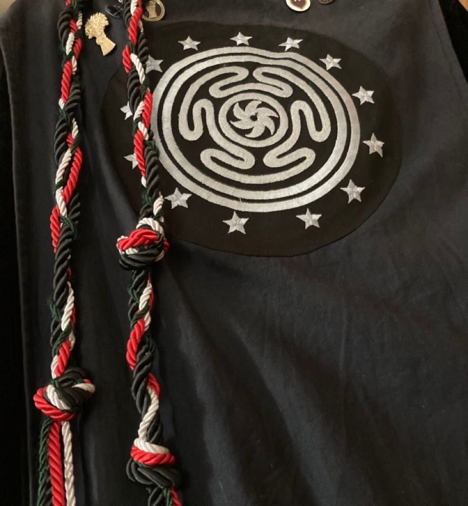 a black shirt with a labyrinth of Hecate and stars on it.