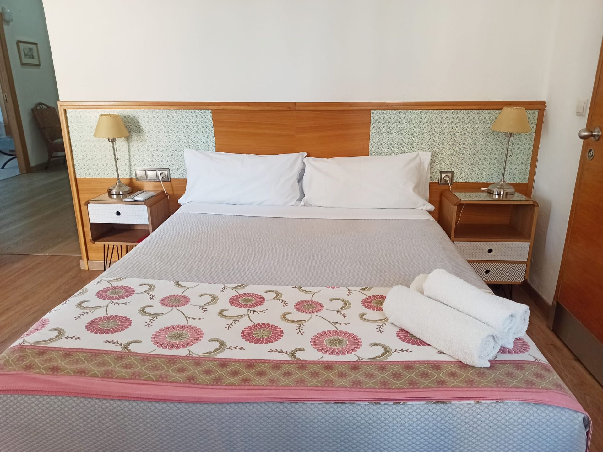 A hotel room with a king size bed and two nightstands