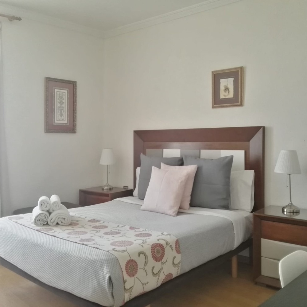 A bedroom with a king size bed and two nightstands